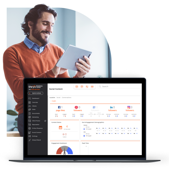 A man on a tablet smiling with a display of a laptop showing Thryv's dashboard